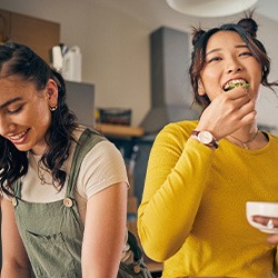 Group of friends enjoying meal in kitchen