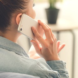 Closeup of patient talking on cellphone at home
