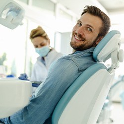 Man smiling while sitting in treatment chair