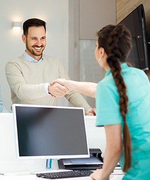 Man checking in at front desk