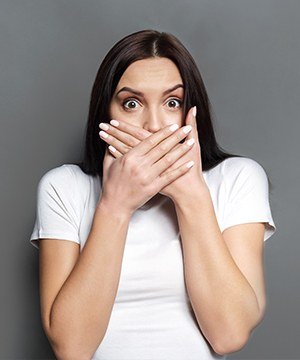 Woman covering her mouth