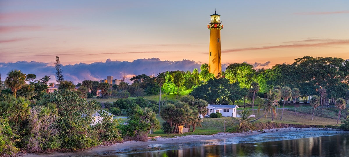 Lighthouse standing above beach town