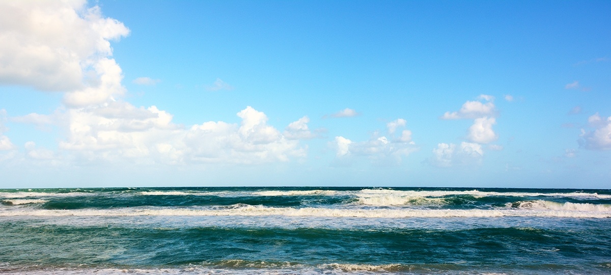 Ocean waves under blue sky