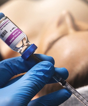 Closeup of syringe of BOTOX next to patient