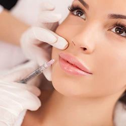 Woman receiving BOTOX injection in lips