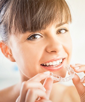 Woman placing Invislaign tray