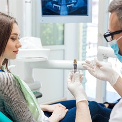 a dentist explaining the cost of dental implants in Jupiter