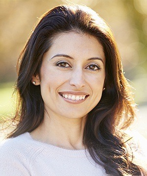 A woman with dental implants in Jupiter smiling outside