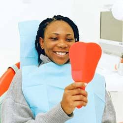 Woman smiling after receiving emergency dental care in Jupiter