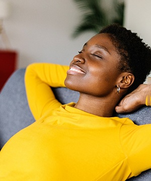 Woman relaxing at home after tooth extraction appointment