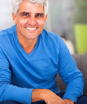 Man smiling in blue shirt
