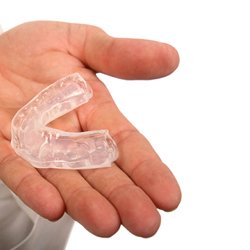 Close up of hand holding clear mouthguard