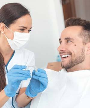 dentist in Jupiter showing a patient how Invisalign works