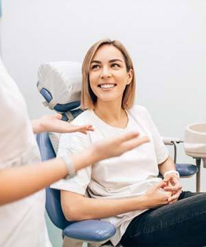 woman talking to her cosmetic dentist in Jupiter about Invisalign