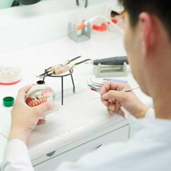 a technician working on constructing new dentures