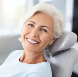 a patient smiling with her new dentures