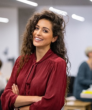 Woman in office smiling after smile makeover in Jupiter, FL