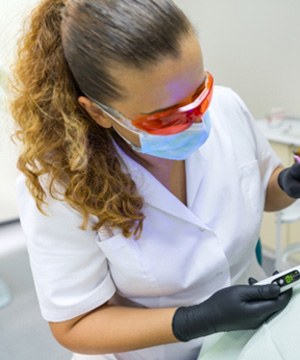 A dentist performing treatment on a sedated patient