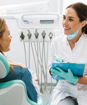 A dentist talking with her patient about oral conscious sedation