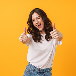 woman giving thumbs up for dental implant post-op instructions in Jupiter