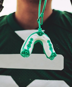 Mouthguard hanging from football helmet