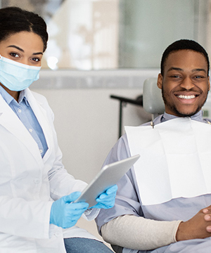 patient smiling while sitting in treatment chair
