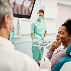 Woman with toothache talking to her dentist