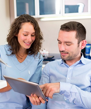 Dentist and patient discussing options for TMJ treatment